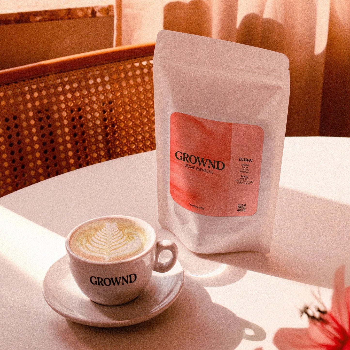 Café with a cup of coffee and a package of GROWND coffee on a table.