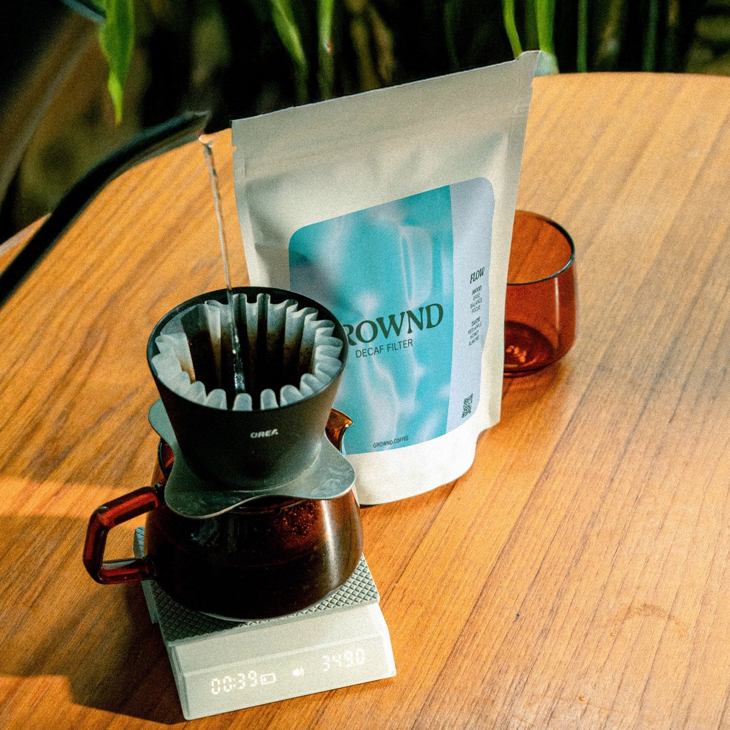 Coffee brewing setup with a bag of coffee grounds on a wooden surface